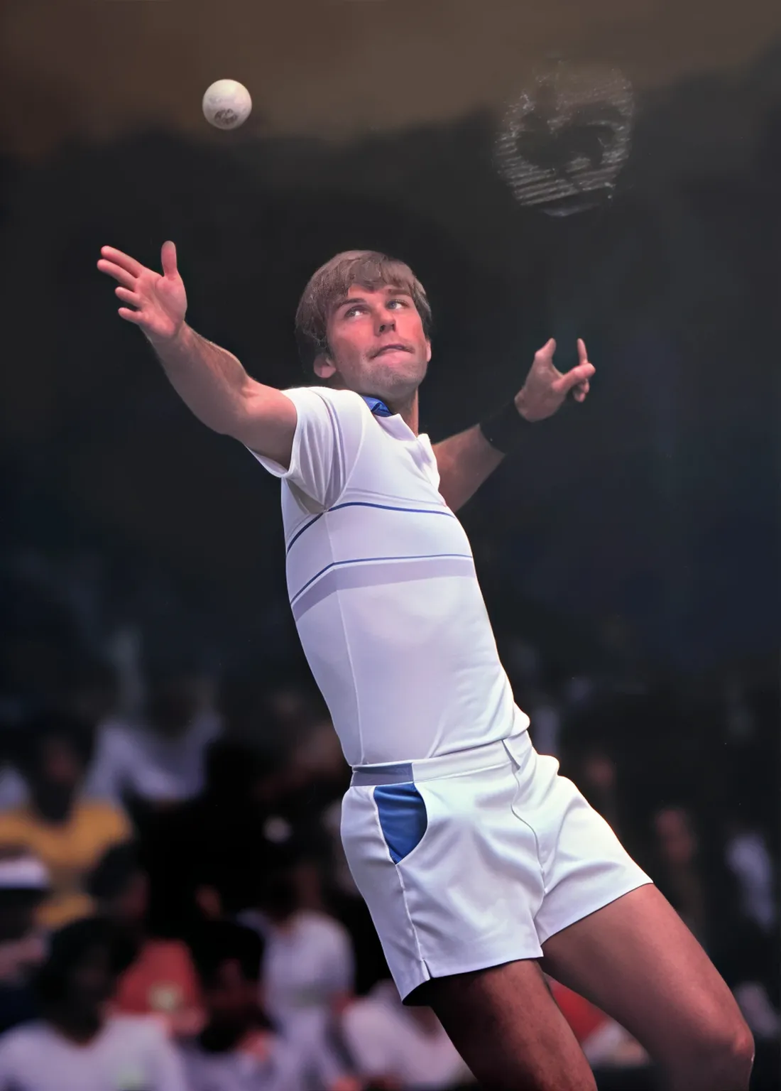 Vintage photo of a tennis player mid-serve